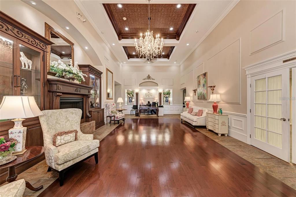 6640 Pineview Terrace, Unit 6640 Bradenton, FL 34203 - Photo 74 of 80 a living room with fireplace furniture and a chandelier