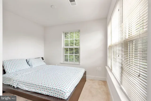 a bedroom with a large bed and a large window