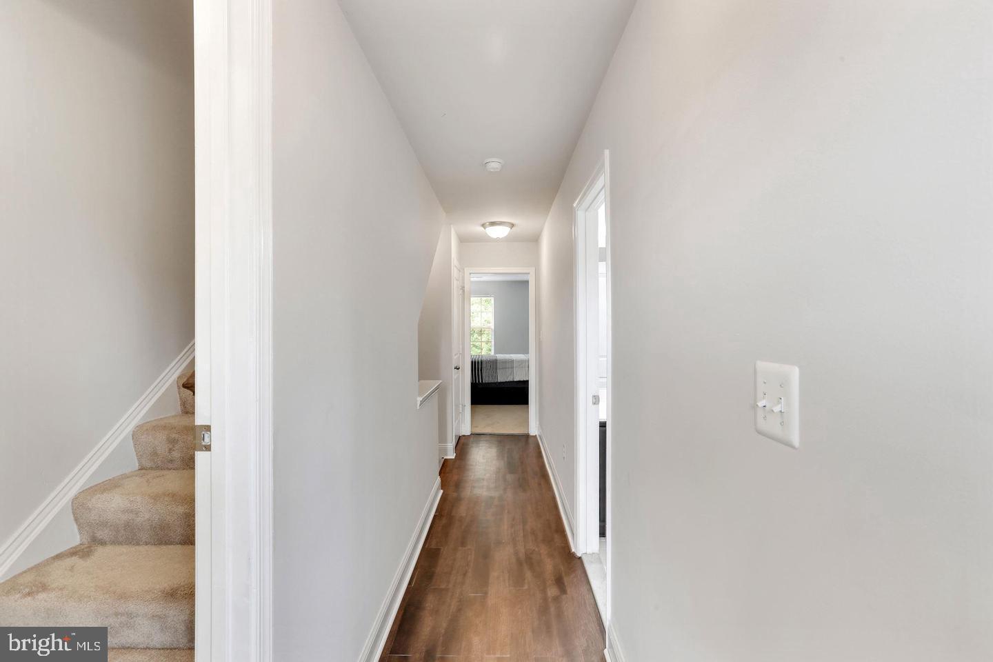 4600 Potomac Highlands Circle Triangle, VA 22172 - Photo 14 of 30 a view of a hallway with wooden floor and a bathroom