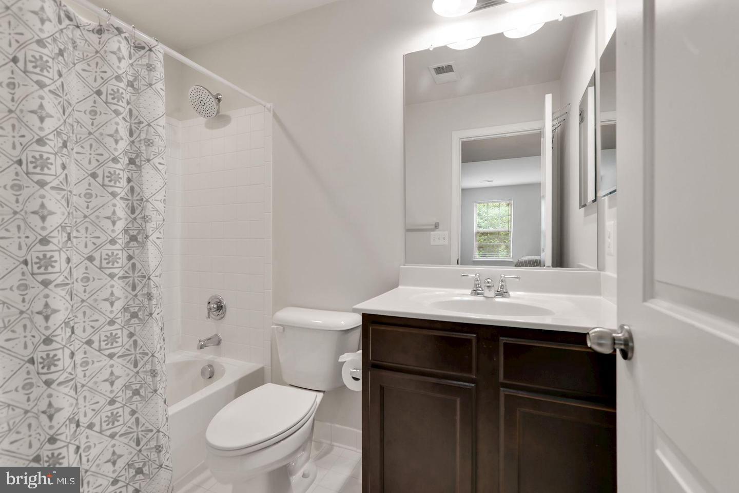 4600 Potomac Highlands Circle Triangle, VA 22172 - Photo 21 of 30 a bathroom with a granite countertop toilet sink and mirror