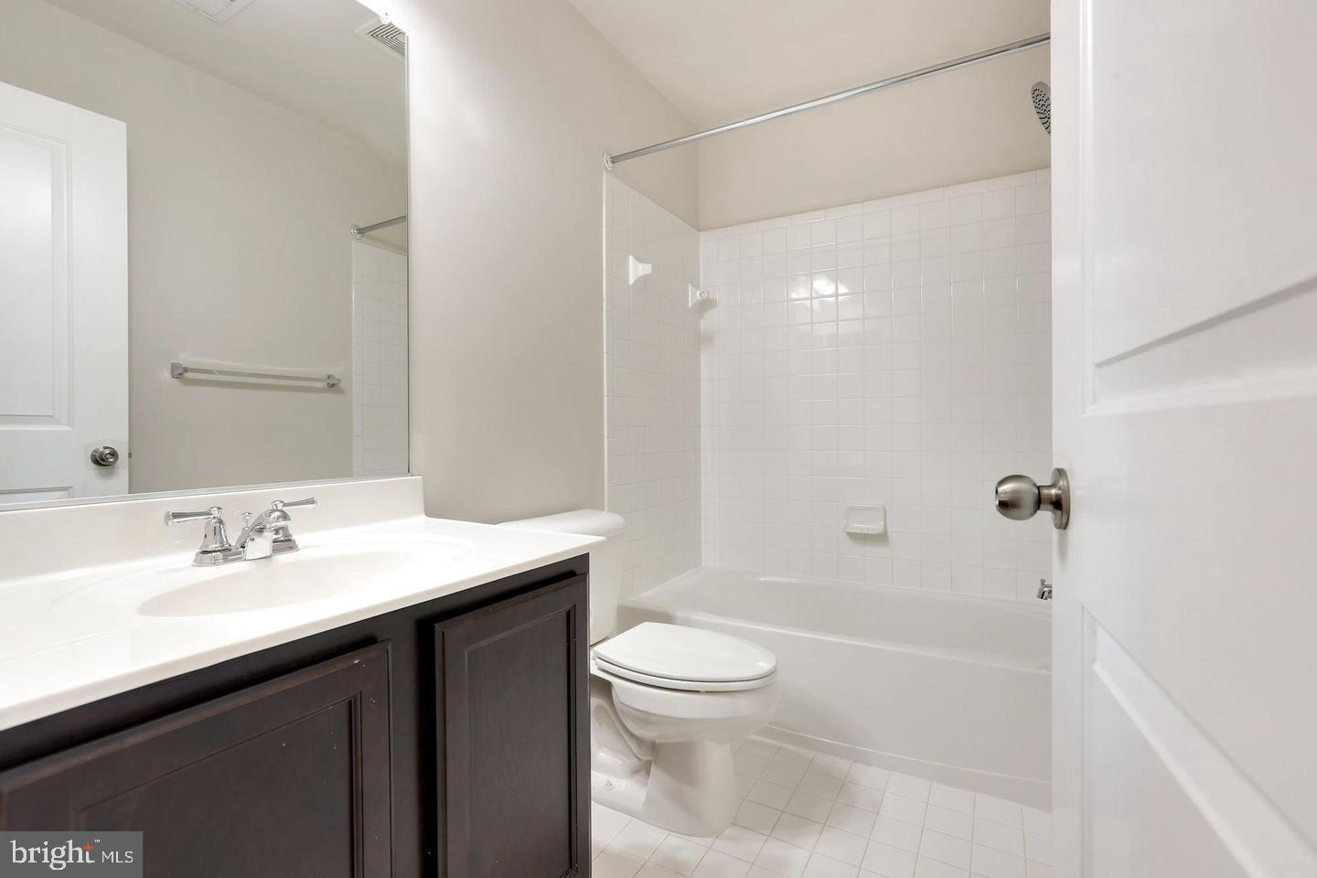 4600 Potomac Highlands Circle Triangle, VA 22172 - Photo 22 of 30 a bathroom with a sink a toilet and shower