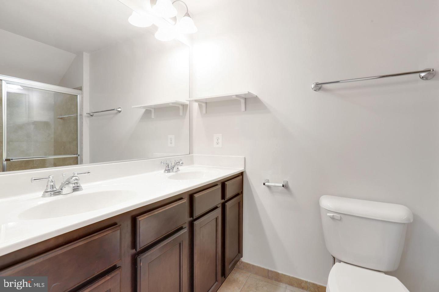 4600 Potomac Highlands Circle Triangle, VA 22172 - Photo 23 of 30 a bathroom with a sink a toilet and a mirror