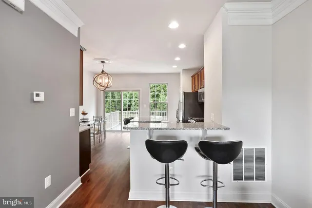 a living room with chairs and a large window