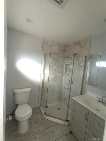 a bathroom with a toilet sink and shower