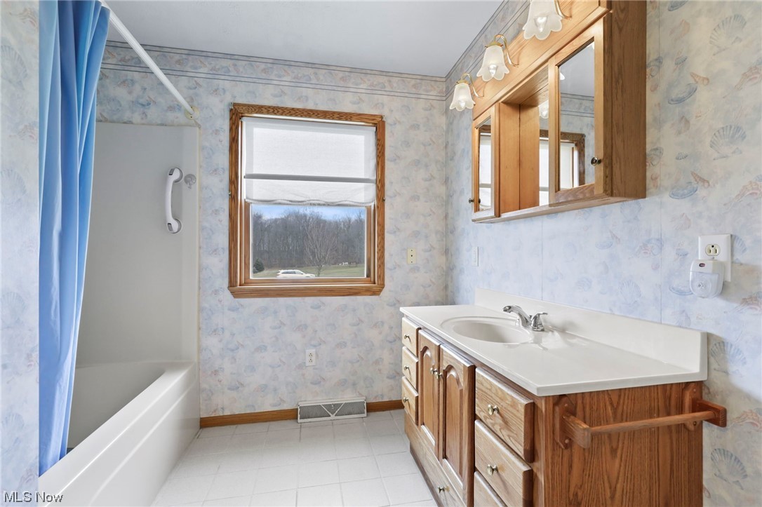 411 Adario West Road Shiloh, OH 44878 - Photo 17 of 35 Bathroom featuring shower / bath combination, tile floors, and oversized vanity