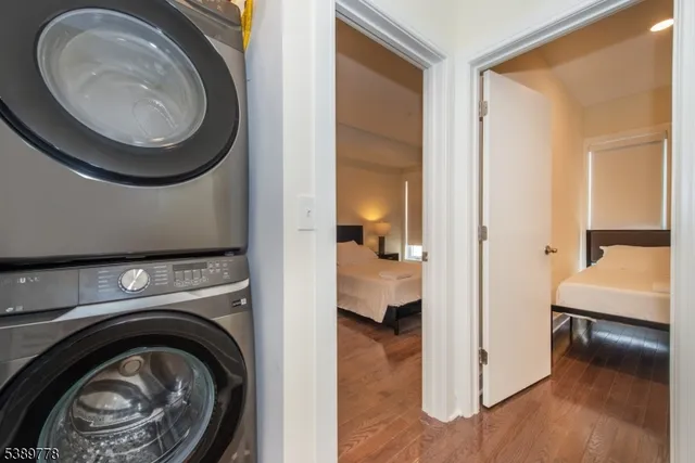 a view of a bedroom with washer and dryer