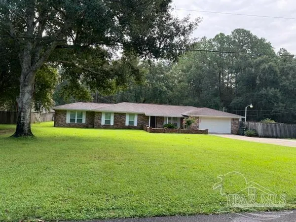 a front view of a house with yard and green space