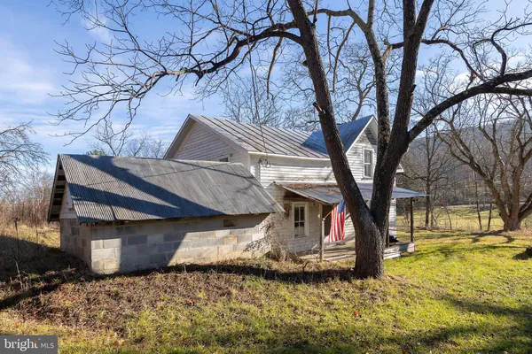 a view of a house with a yard covered with snow in the background