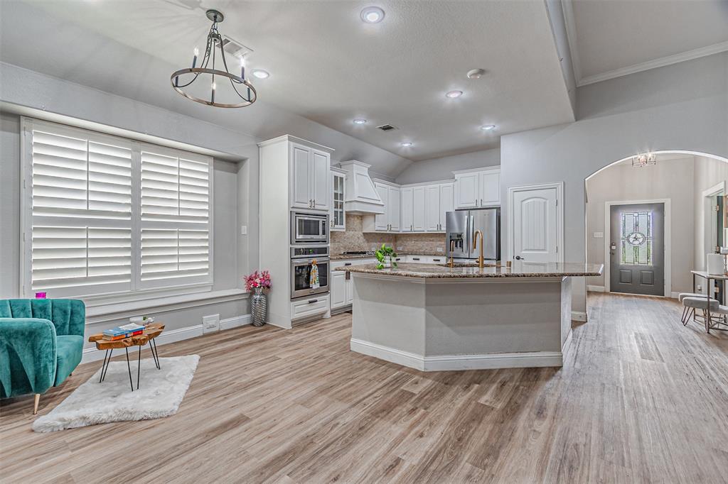 1805 Stetson Way Allen, TX 75002 - Photo 6 of 22 Spacious open concept interior featuring wood-finish flooring, recessed lighting, and a vaulted ceiling