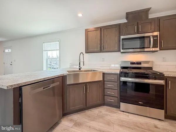 a kitchen with a sink stove and microwave