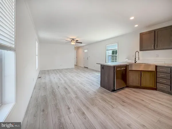 a view wooden floor kitchen center island wooden floor and electronic appliances