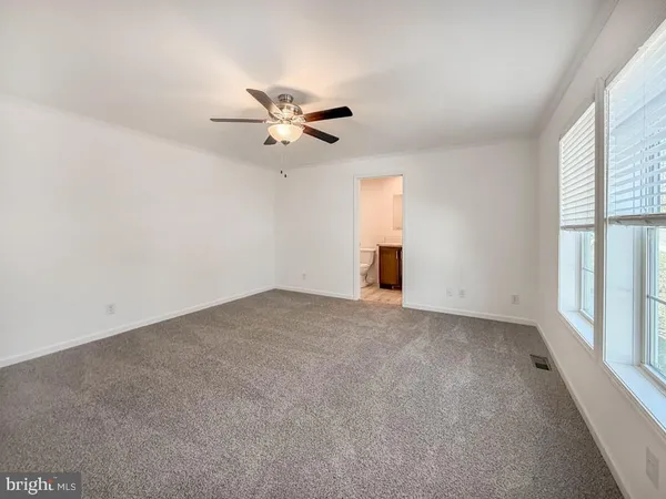 a view of empty room with ceiling fan