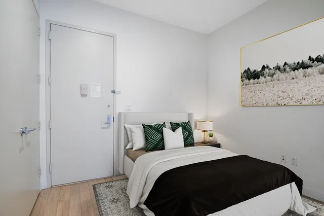 a view of a hallway with wooden floor and a living room