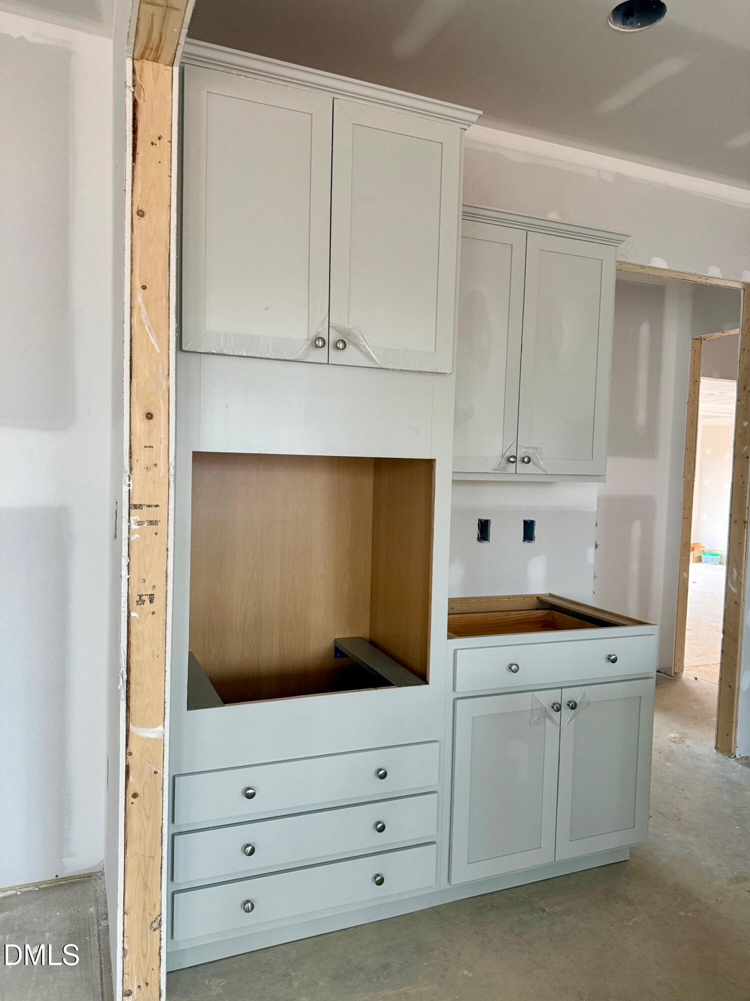 243 Seahawk Way Zebulon, NC 27597 - Photo 4 of 5 a kitchen with white cabinets and white appliances