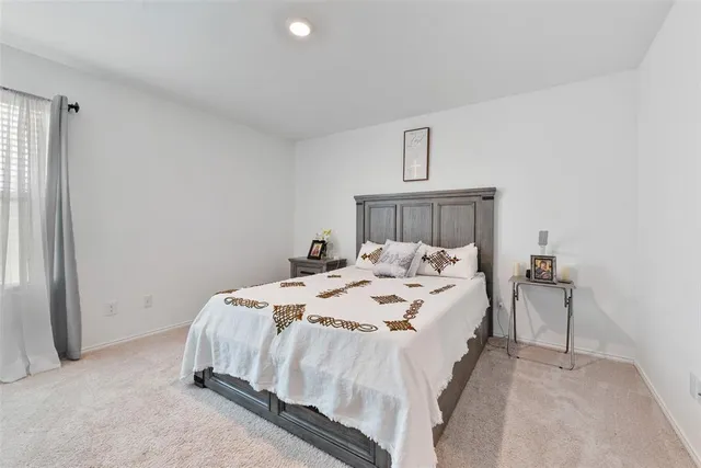 a bed sitting in a bedroom next to a window