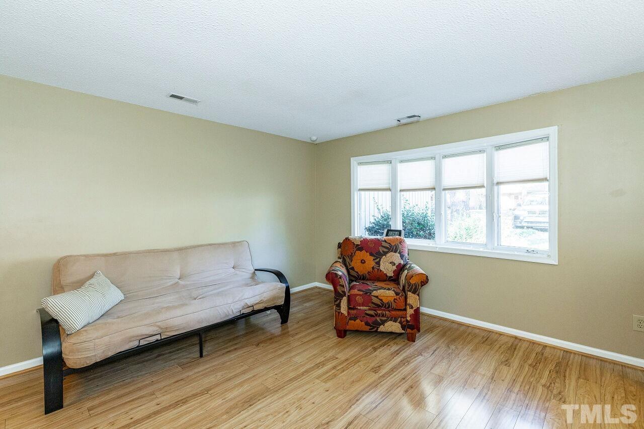 7902 Yester Court Raleigh, NC 27615 - Photo 8 of 30 a living room with furniture and a floor to ceiling window