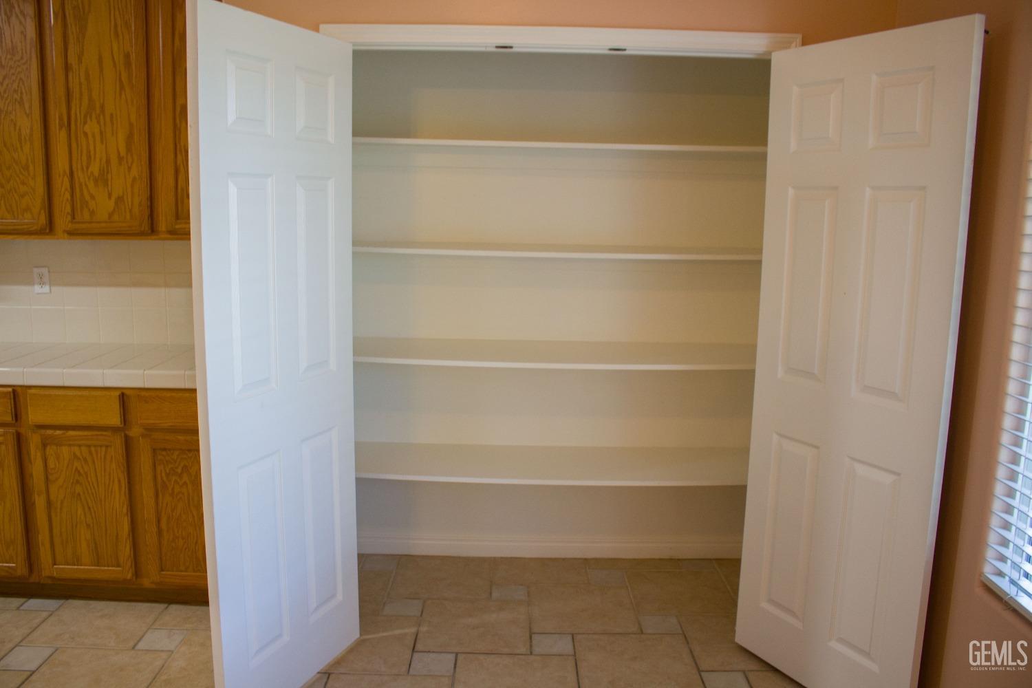 Undisclosed Address Bakersfield, CA 93312 - Photo 14 of 44 a view of walk in closet with empty racks