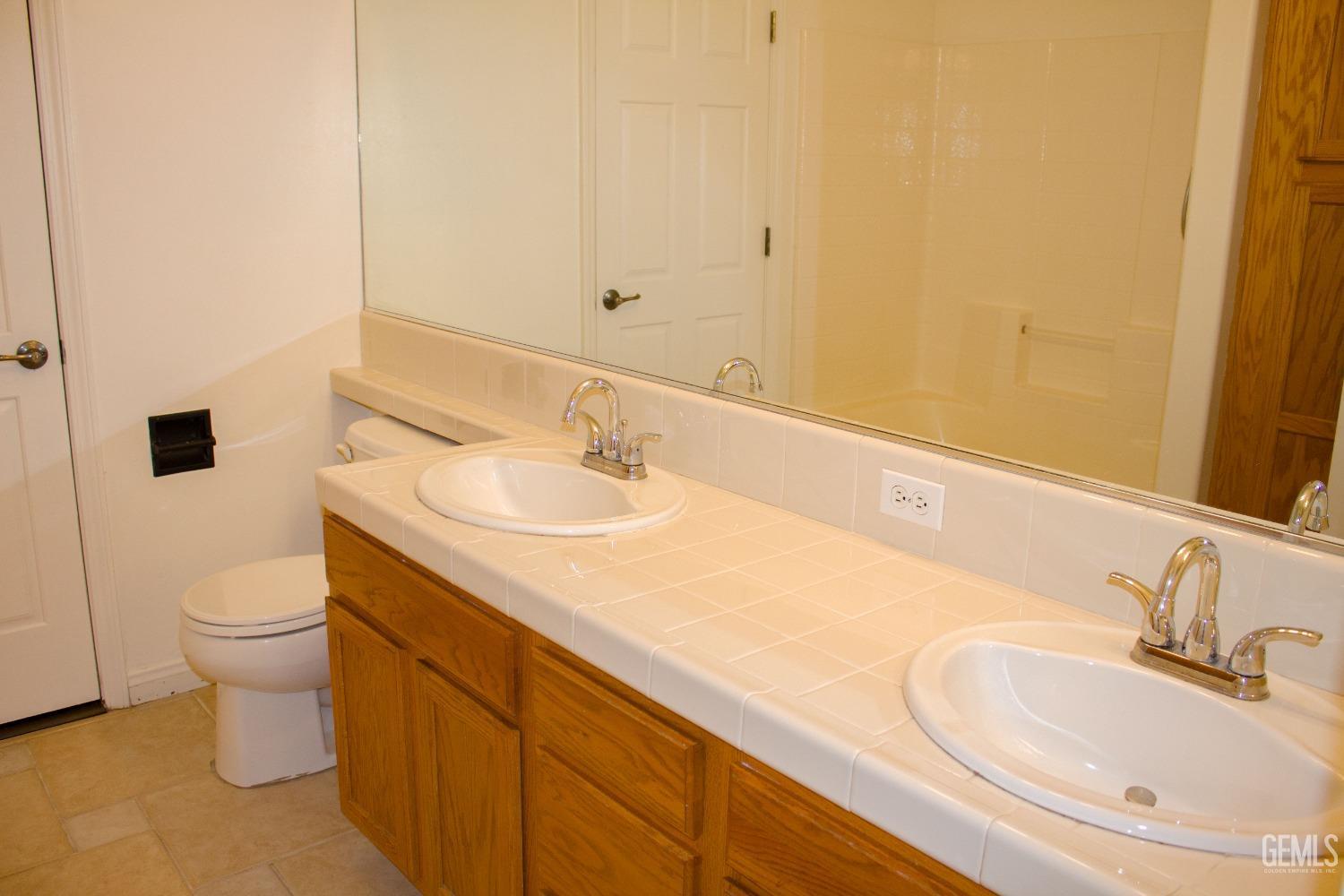 Undisclosed Address Bakersfield, CA 93312 - Photo 18 of 44 a bathroom with a sink and a toilet