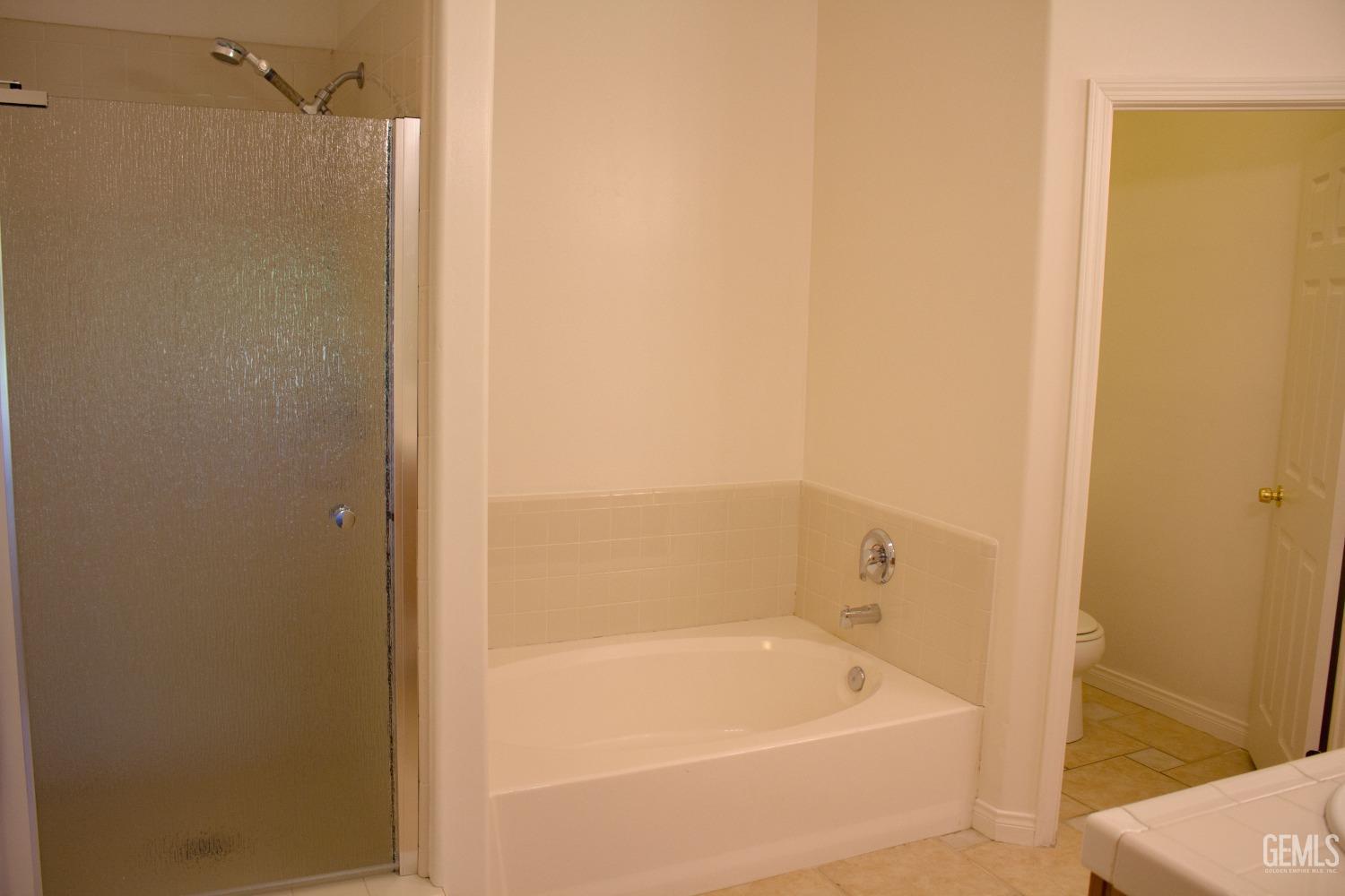 Undisclosed Address Bakersfield, CA 93312 - Photo 26 of 44 a bathroom with a bathtub