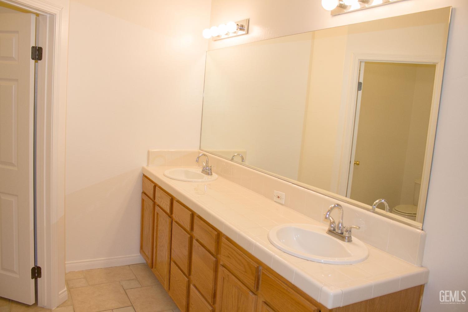 Undisclosed Address Bakersfield, CA 93312 - Photo 27 of 44 a bathroom with a sink and a mirror