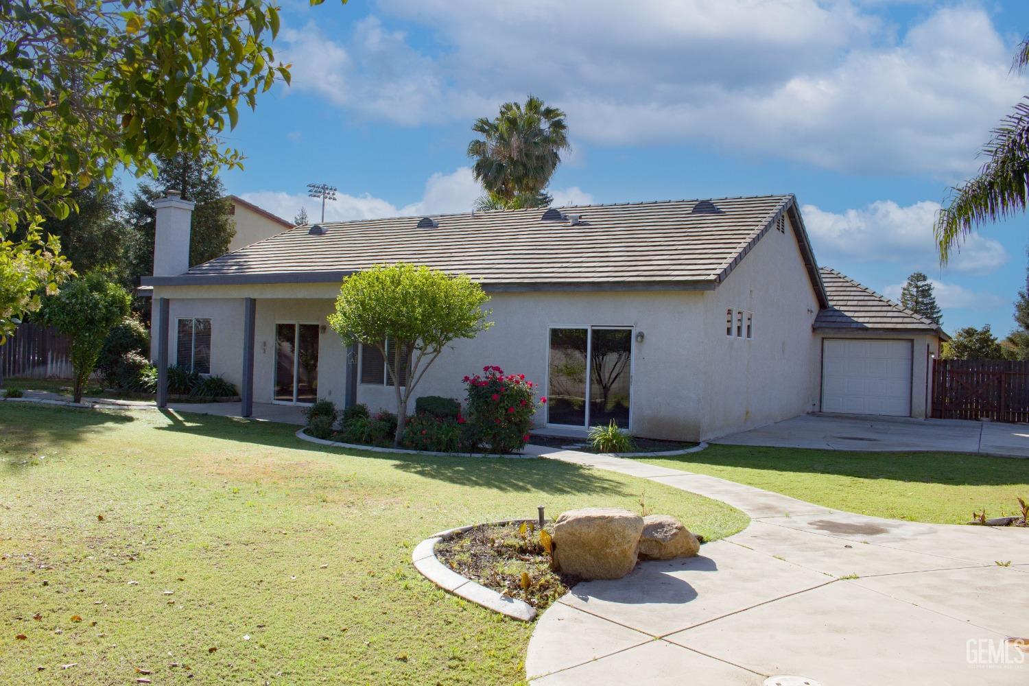 Undisclosed Address Bakersfield, CA 93312 - Photo 30 of 44 a view of a house with swimming pool and a yard