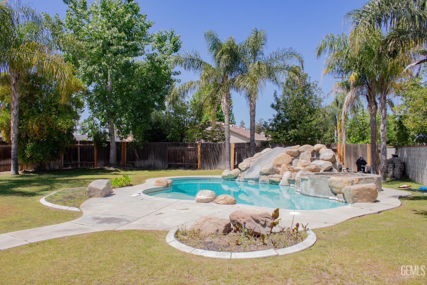 Undisclosed Address Bakersfield, CA 93312 - Photo 34 of 44 a view of a swimming pool with a yard