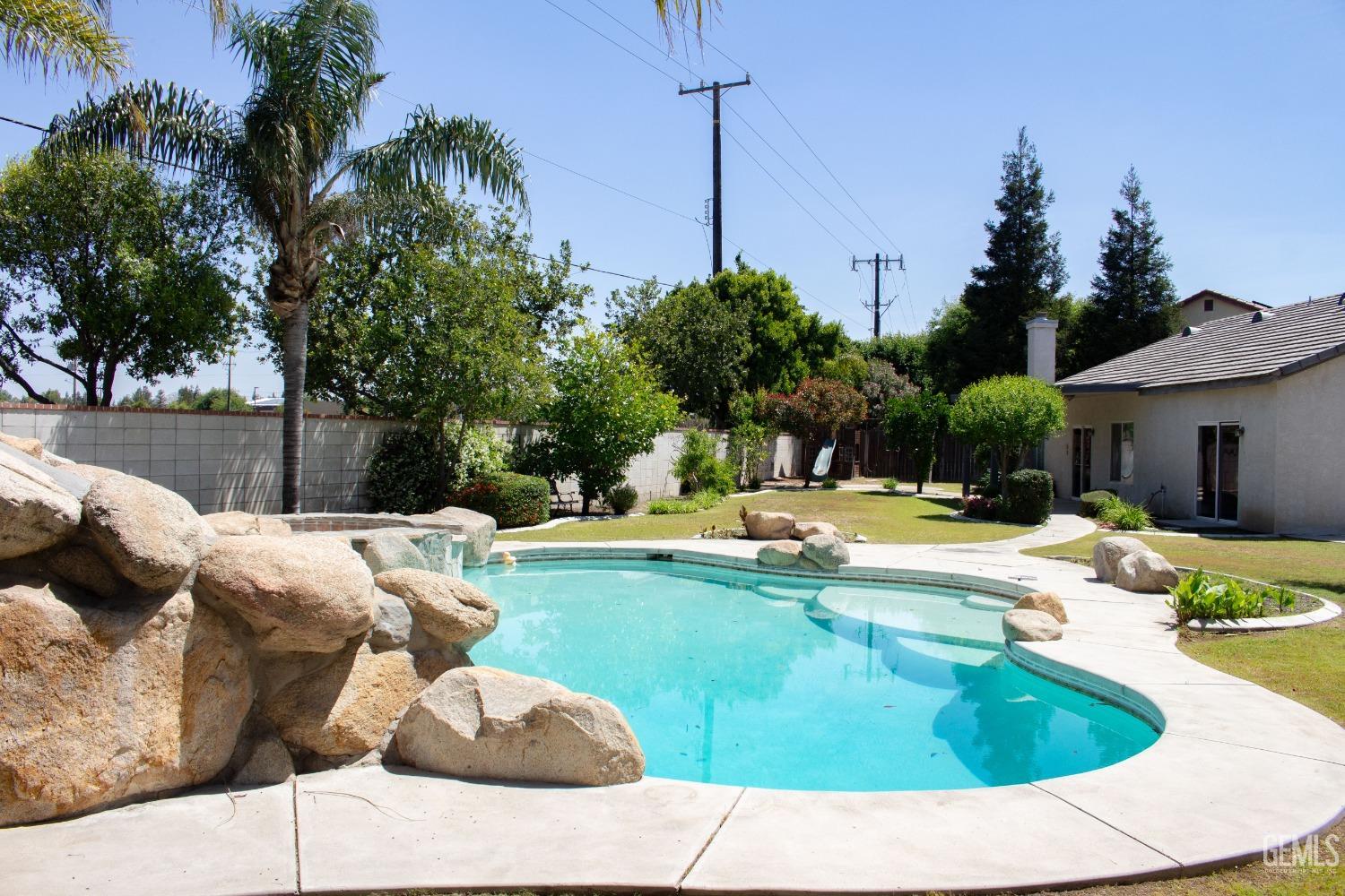 Undisclosed Address Bakersfield, CA 93312 - Photo 40 of 44 a view of swimming pool with seating space and trees