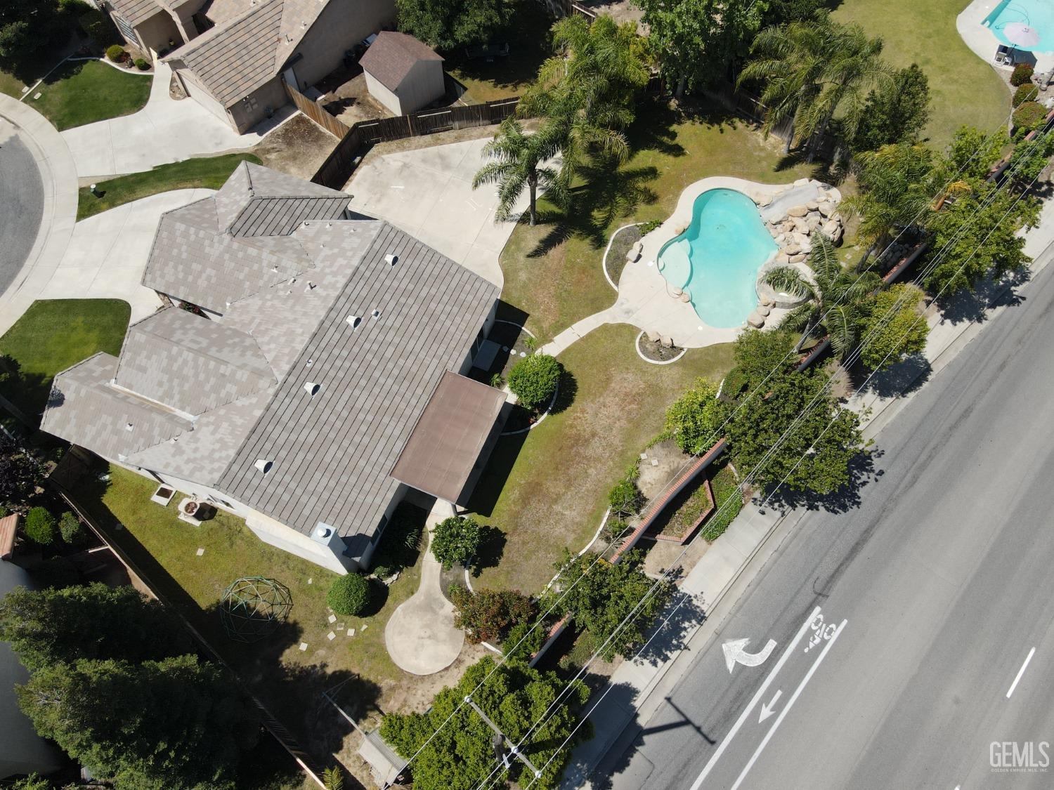 Undisclosed Address Bakersfield, CA 93312 - Photo 42 of 44 an aerial view of a house with a yard and swimming pool