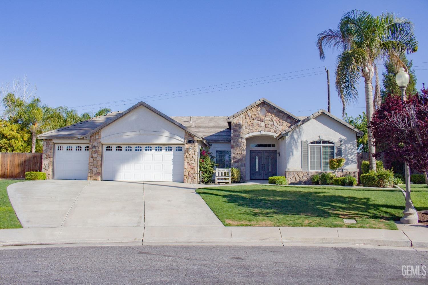 Undisclosed Address Bakersfield, CA 93312 - Photo 44 of 44 a front view of a house with a yard and garage