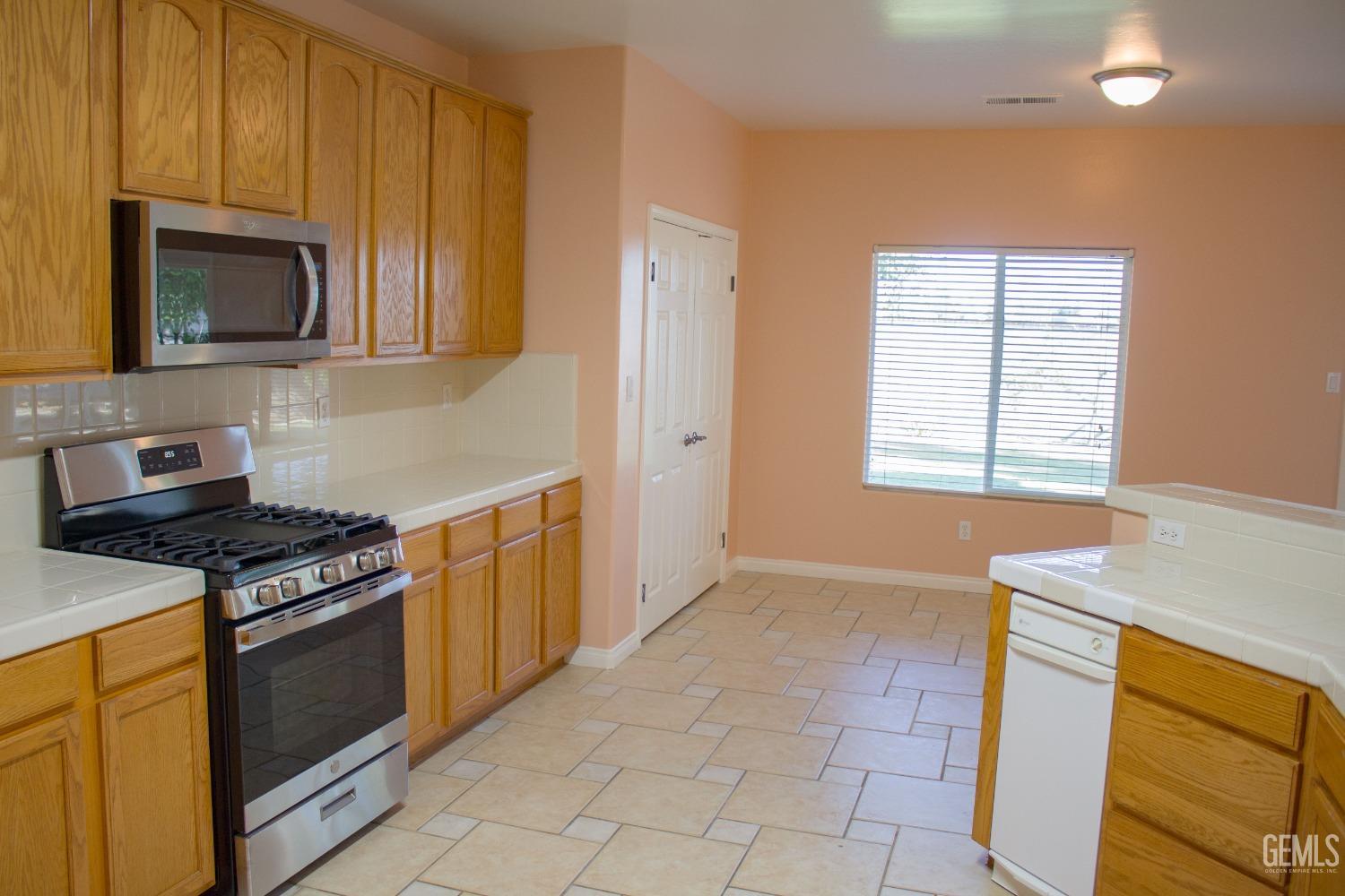 Undisclosed Address Bakersfield, CA 93312 - Photo 8 of 44 a kitchen with a stove microwave and sink