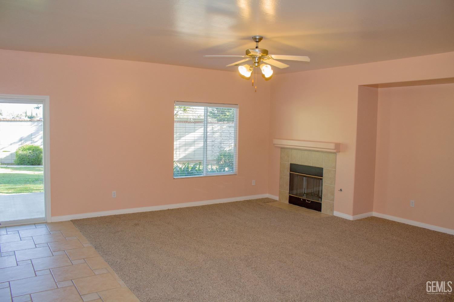 Undisclosed Address Bakersfield, CA 93312 - Photo 9 of 44 en empty room with windows fireplace and fan