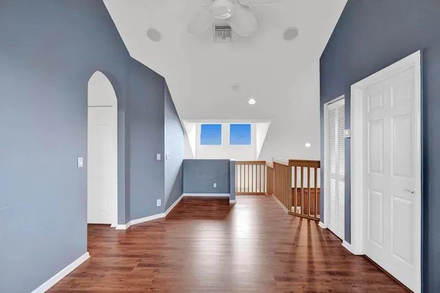 a view of empty room with wooden floor