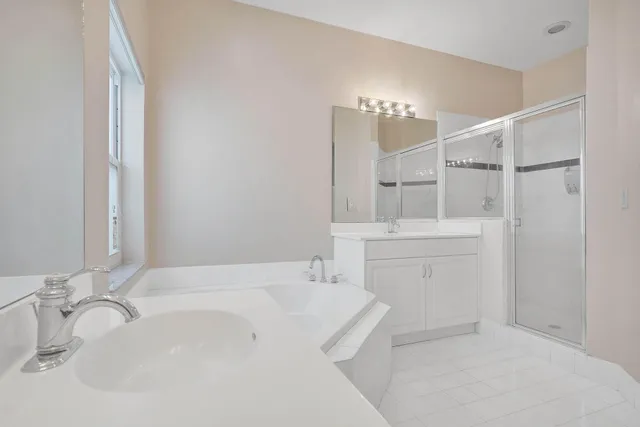 a bathroom with a bathtub a sink and a window