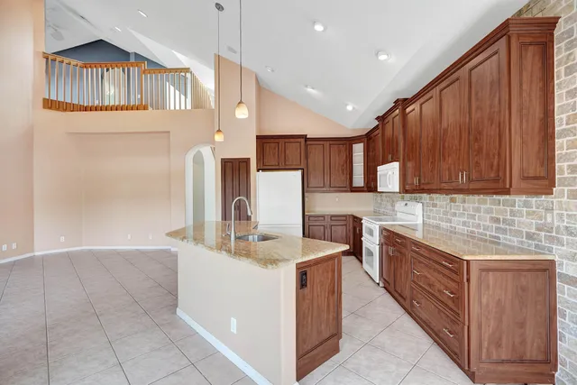 a kitchen with a sink refrigerator and microwave