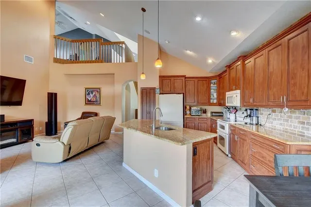 a kitchen that has a lot of cabinets and refrigerator