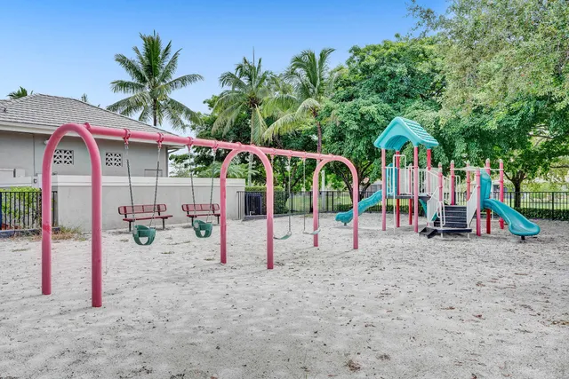 a view of a patio with table and chairs potted plants and palm tree