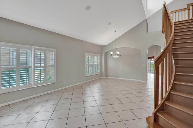 a view of an empty room with staircase