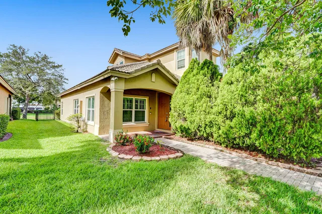 a backyard of a house with table and chairs
