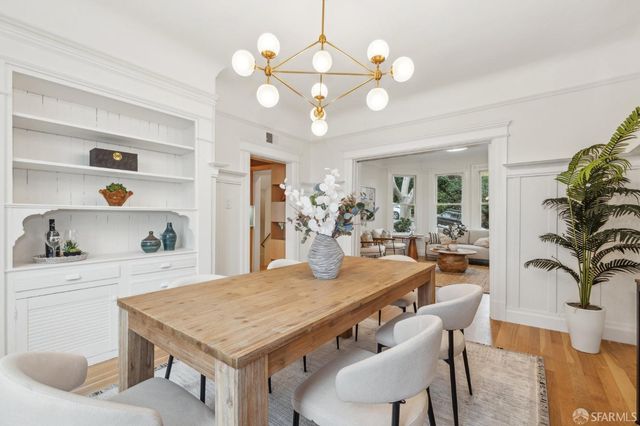 a view of a dining room with furniture and chandelier