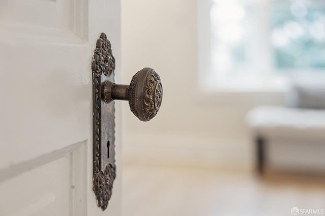 a bedroom with a bed a chandelier and a mirror