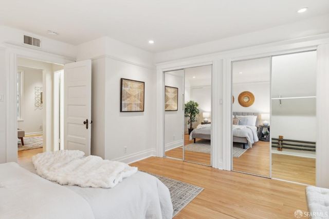 a bathroom with a granite countertop sink a mirror and shower