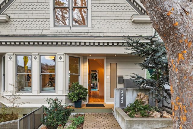 a view of a room with wooden floor and door
