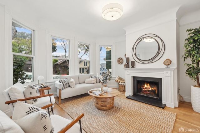 a living room with a fireplace with wooden floor