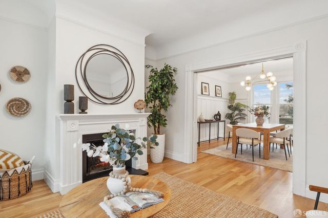 a view of a dining room with furniture and chandelier