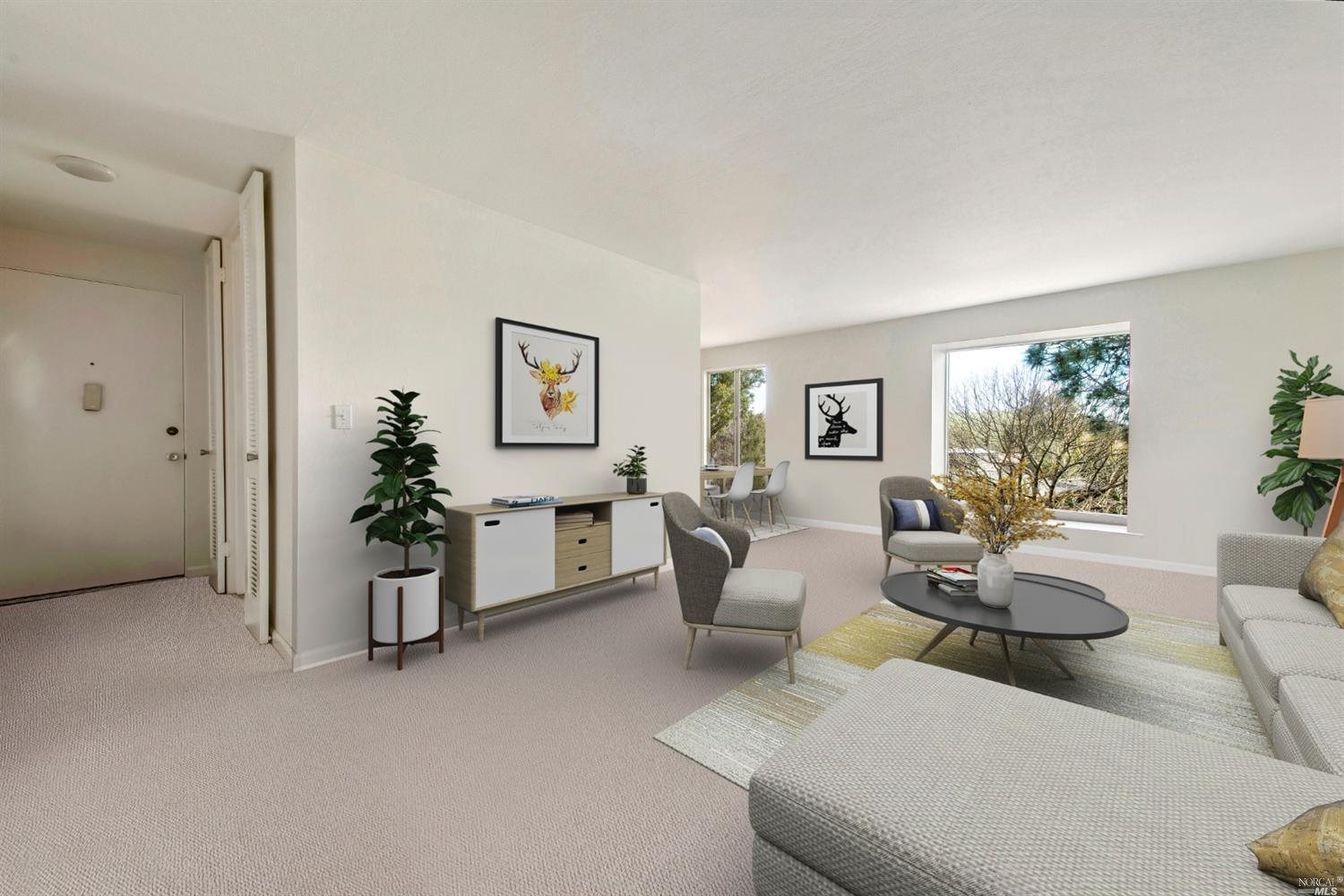 a living room with furniture and a potted plant