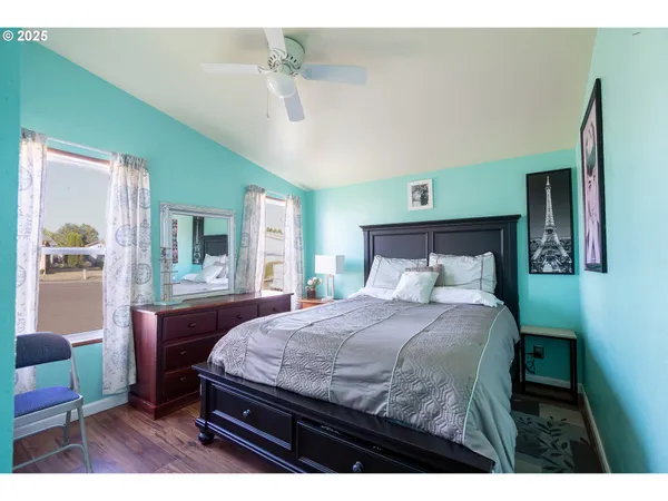 a bedroom with a bed table and chair