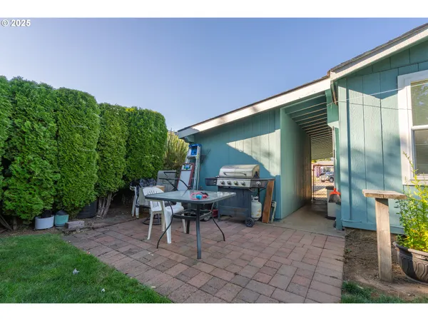 a view of a patio with table and chairs and potted plants