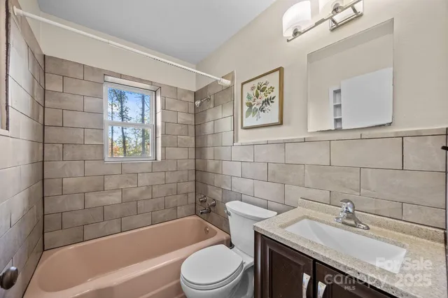 a bathroom with a sink a toilet and bathtub