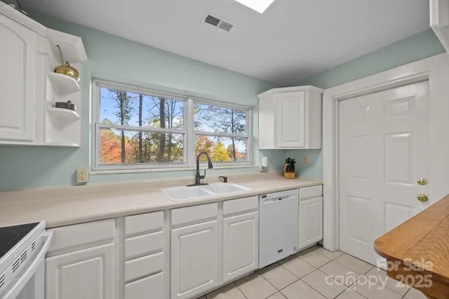 a kitchen with a sink cabinets and window