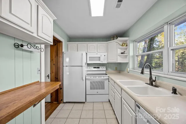 a kitchen with a sink stove and refrigerator